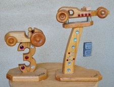 Pair of unique wooden sculpture trophy in the shape of cars on stands picture