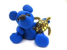 Blue polymer clay bear with a sea turtle picture