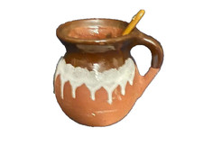 Mi Patria Brown Clay Mug, likely handmade and handpainted with spoon picture