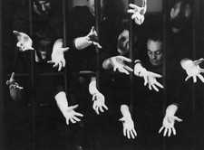 Men and women reaching out to a light through prison bars circa 1960 Old Photo picture